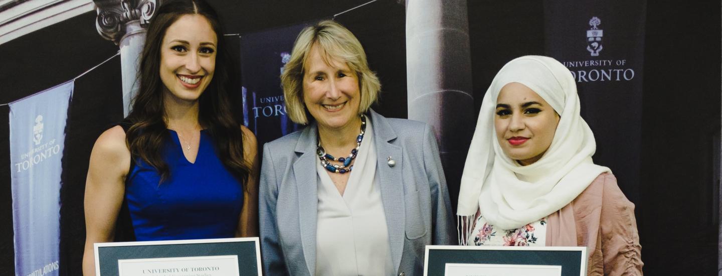 Maureen McDonald standing with two female graduates at SCS Celebrates grad ceremony
