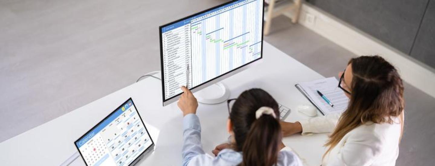 two women working at a computer