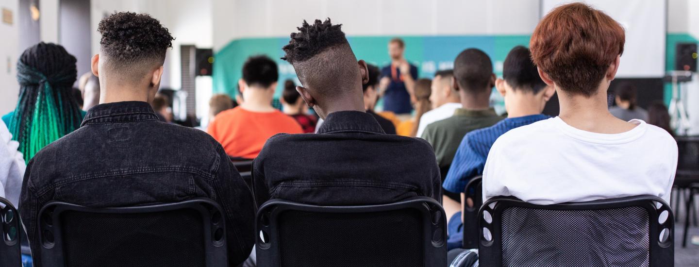 Adult students sit in a classroom