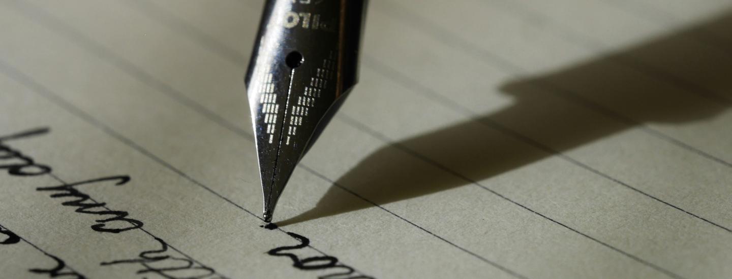 Close up of fountain pen writing on a lined page