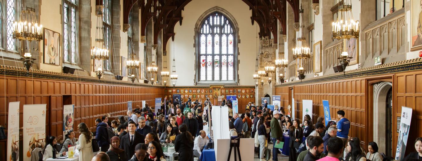 The U of T Hart House Great Hall is full of people visiting exhibitor booths at the SCS Career Expo