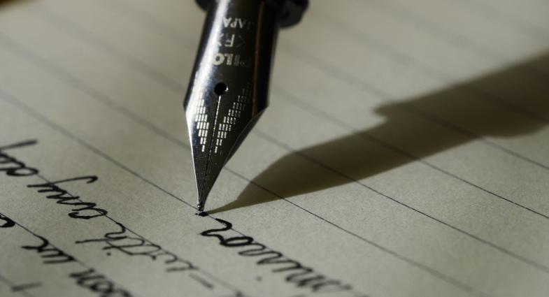 Close up of fountain pen writing on a lined page
