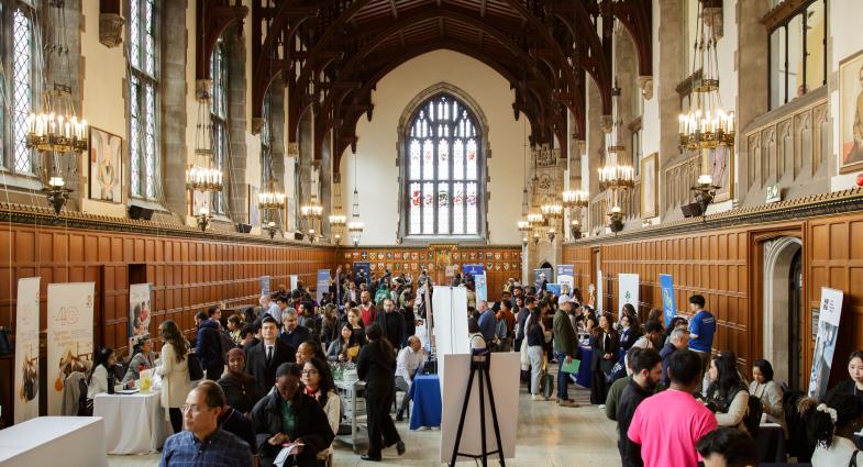 The U of T Hart House Great Hall is full of people visiting exhibitor booths at the SCS Career Expo