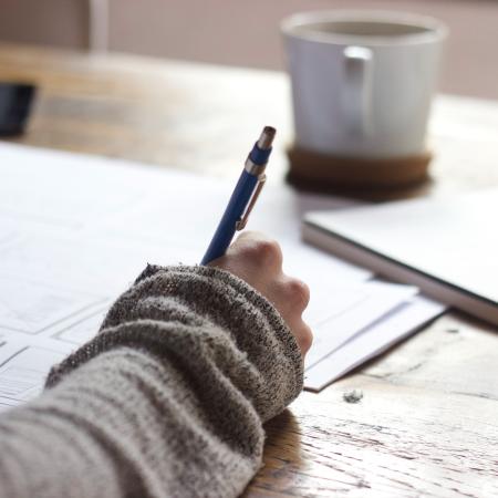A person writing in a notebook